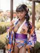 A woman in a kimono posing for the camera.