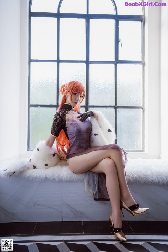 A woman sitting on a window sill with a teddy bear.