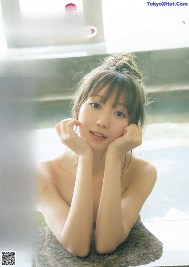 A magazine with a picture of a woman in a bathtub.
