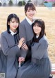 A group of young women in school uniforms posing for a picture.